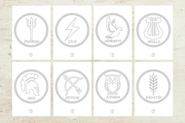 A collection of 16 Greek Gods symbols in various sizes, displayed on a wooden background. Each symbol represents a different Greek god or goddess, with the corresponding deity's name below each symbol.
