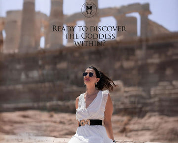 A woman in a white dress sitting in front of a ancient ruins-like background, with text overlay 'Ready to discover the Goddess within?'.